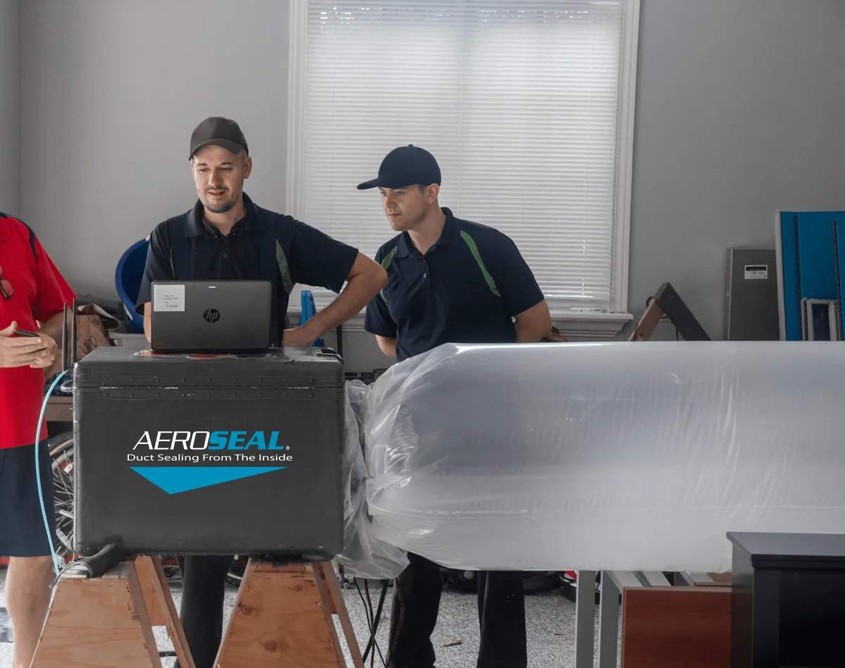 2 men using an aeroseal machine